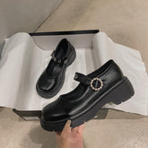 Sandalias negras vintage de piel con hebilla de flor y brillo mate
